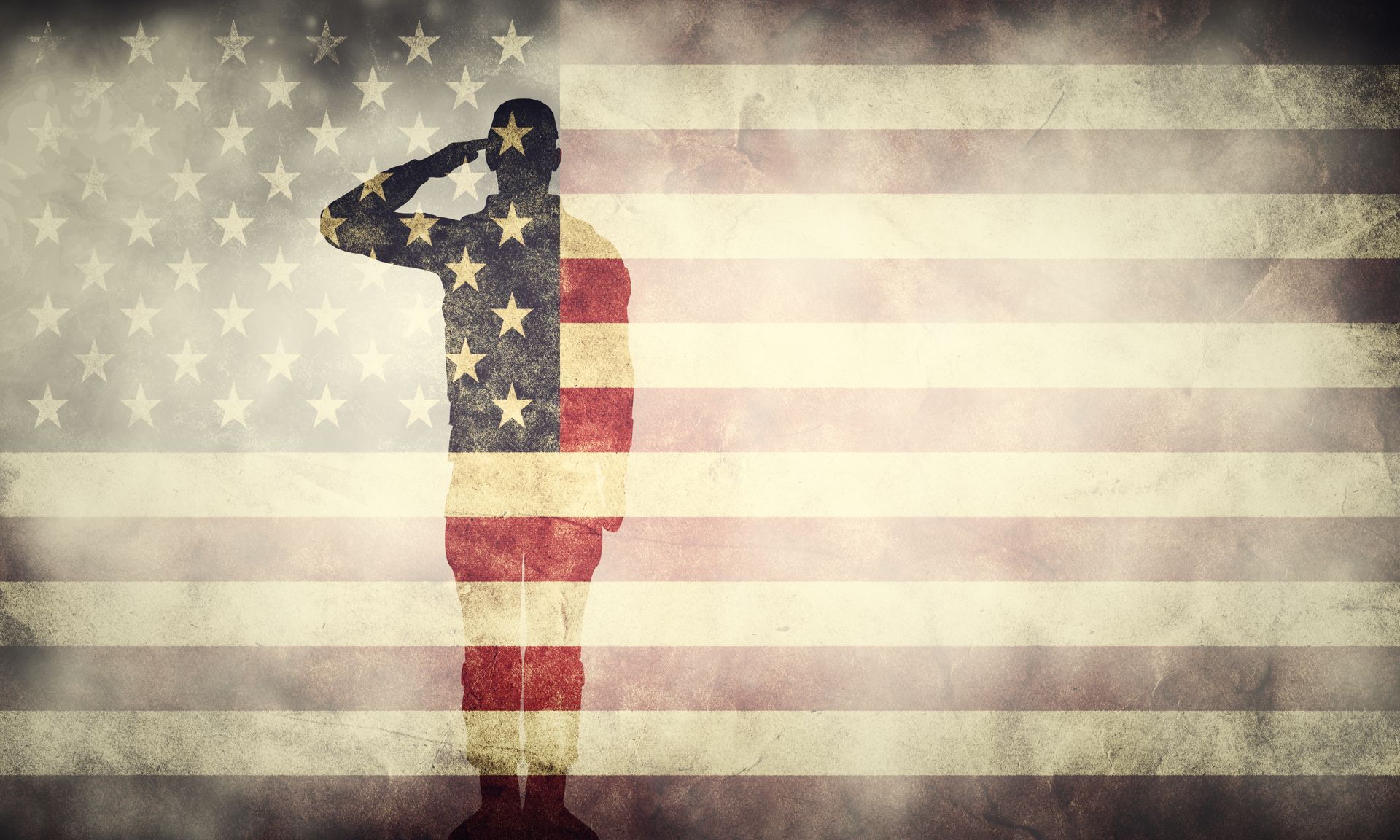 Silhouette of a man saluting American flag