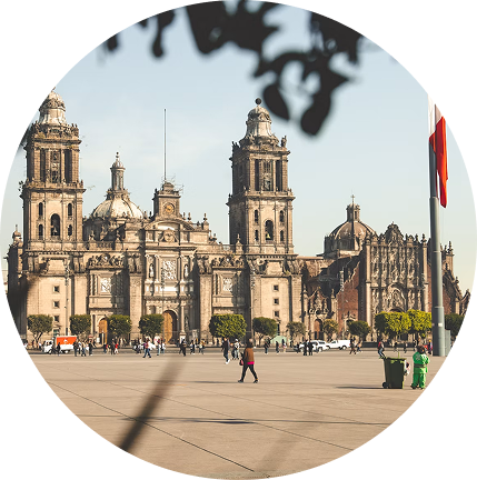 Cathedral Square in Mexico City with the Metropolitan Cathedral, wide plaza, and a few pedestrians under a clear sky