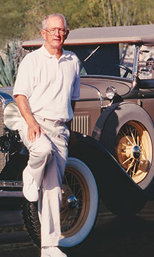 Jack Gosch, Gosch Auto Group Founder, Posing with Model-T Ford Car