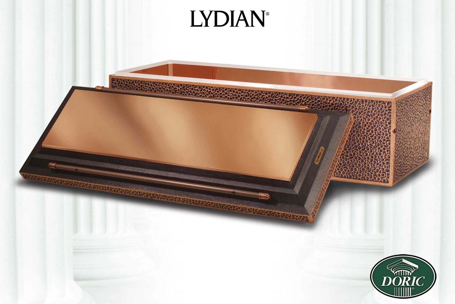 A Lydian bronze burial vault with a polished top and textured sides, presented against a white column background.