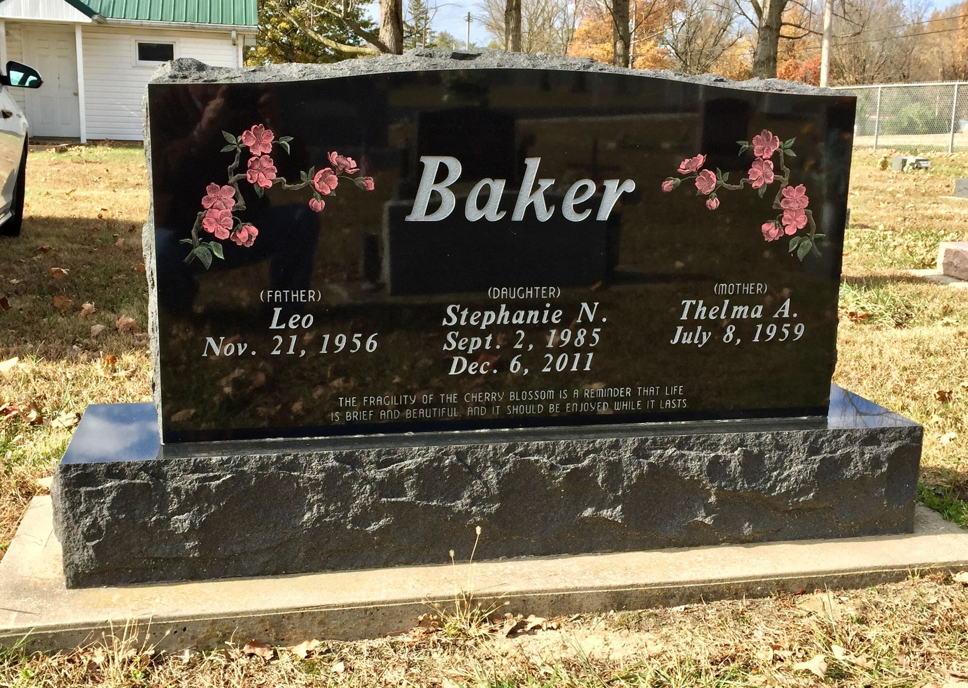 A black granite gravestone engraved with