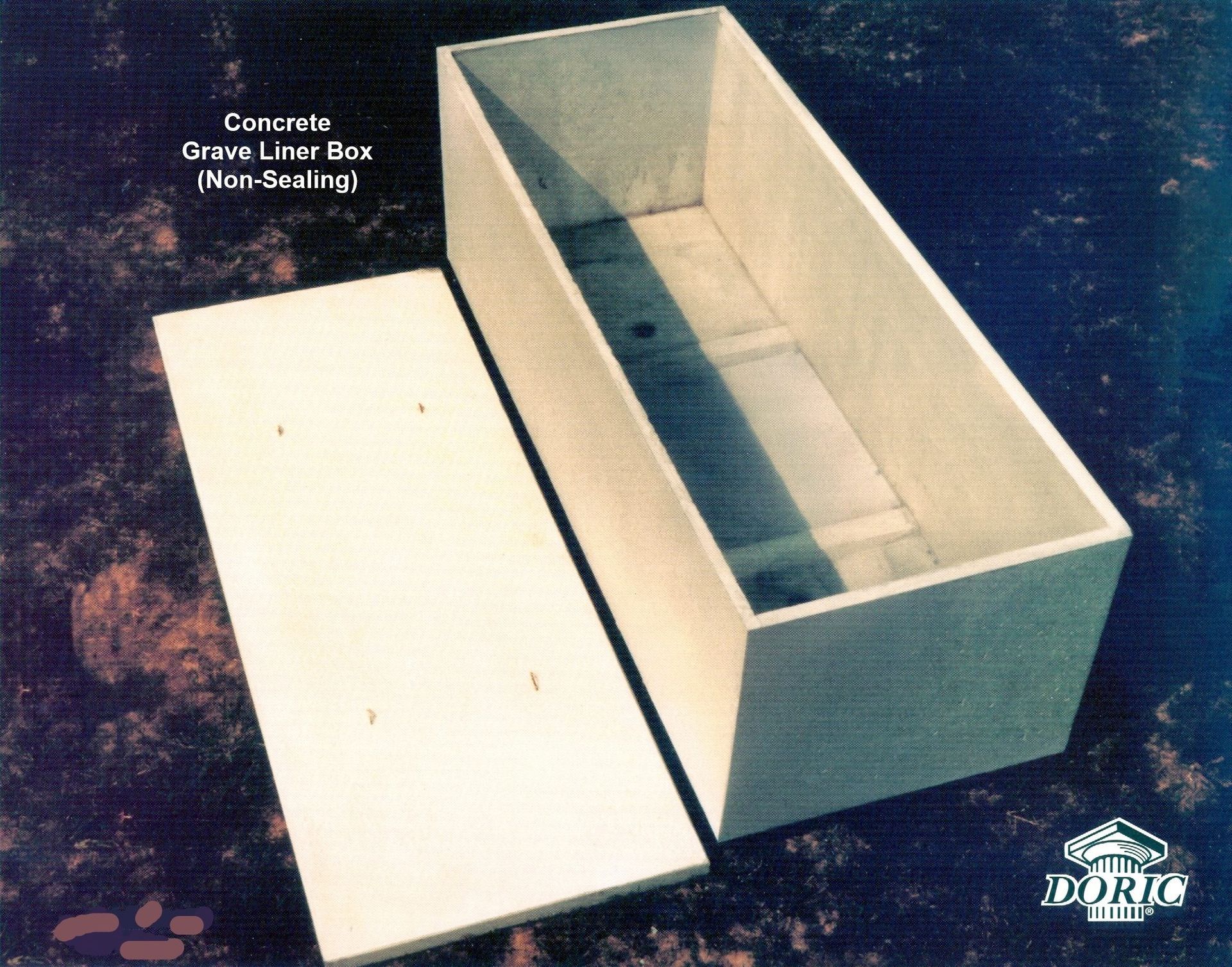 A rectangular concrete grave liner box and its matching lid, displayed against a dark, textured background.