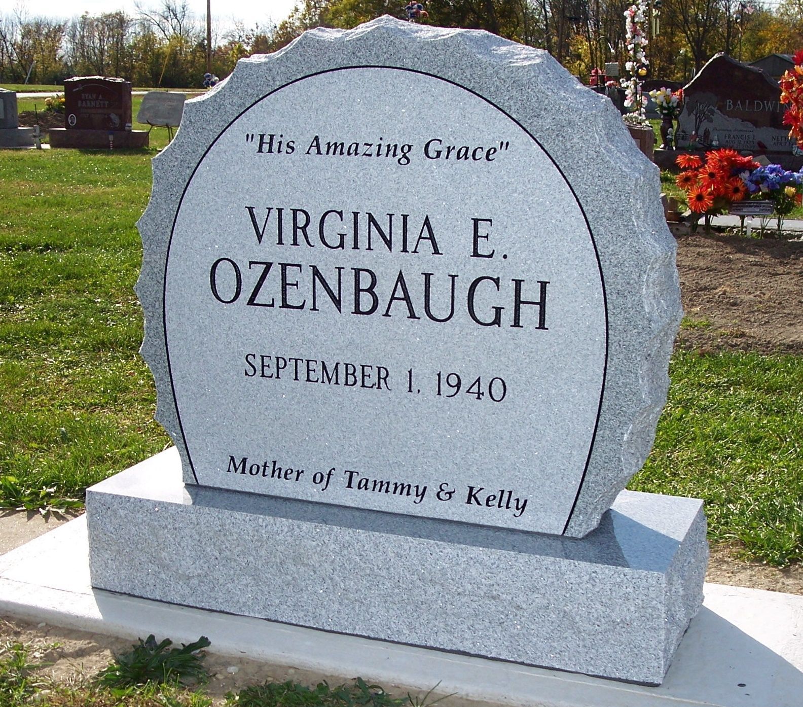 A gray granite headstone for Virginia E. Ozenbaugh, inscribed with