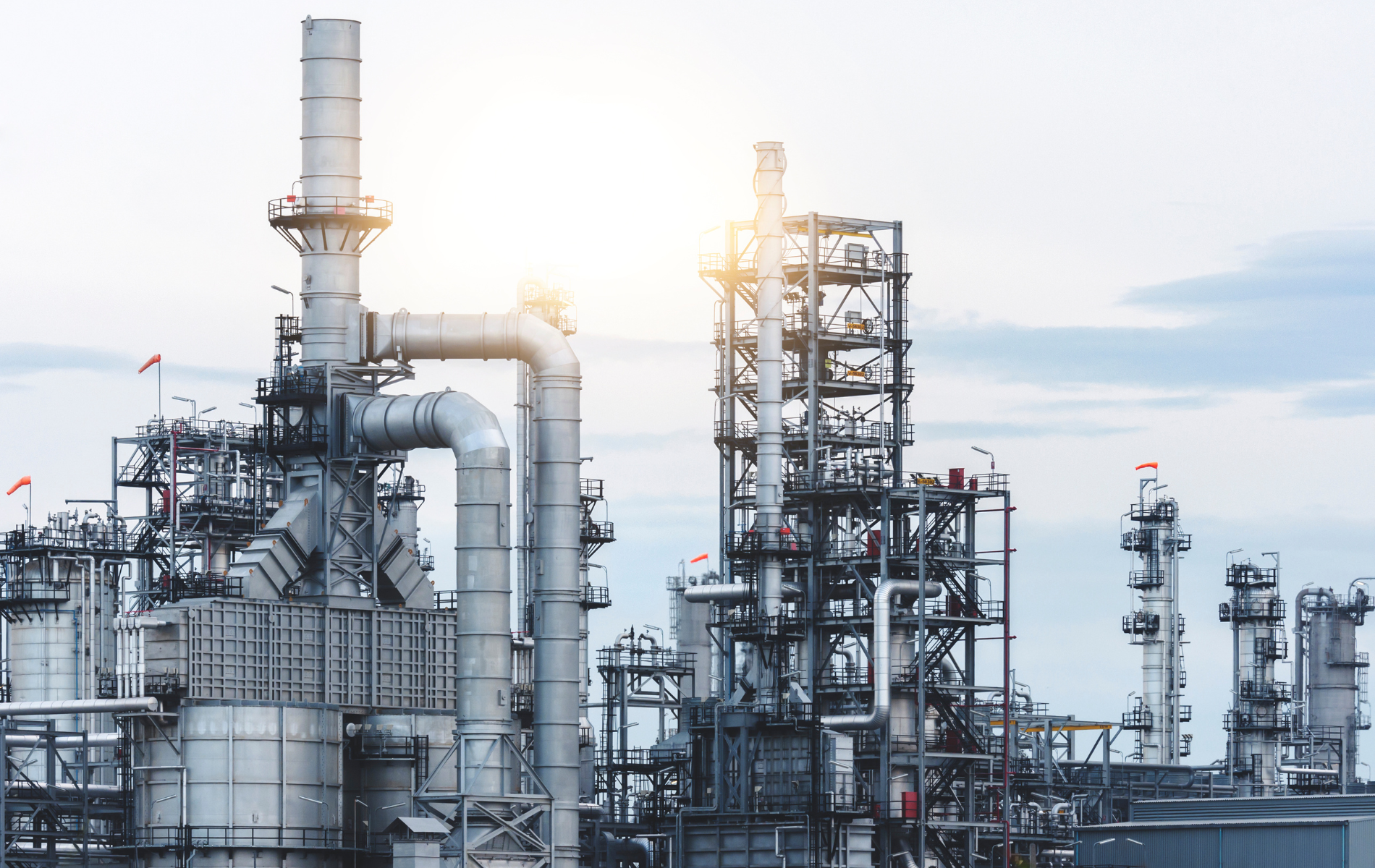 A large industrial plant with a lot of pipes and chimneys.