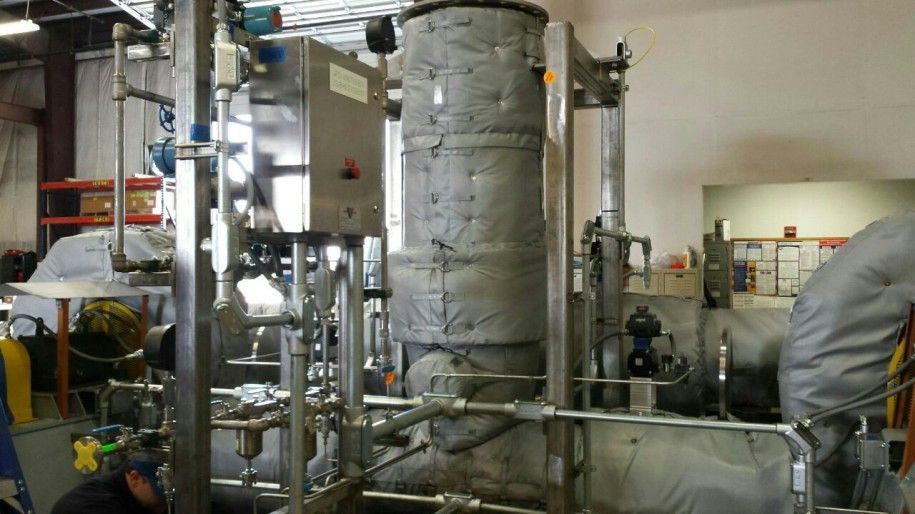 A man is working on a machine in a factory.