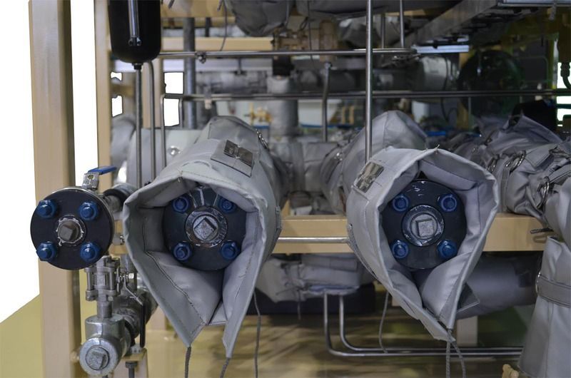 A machine with a lot of pipes and valves on it.