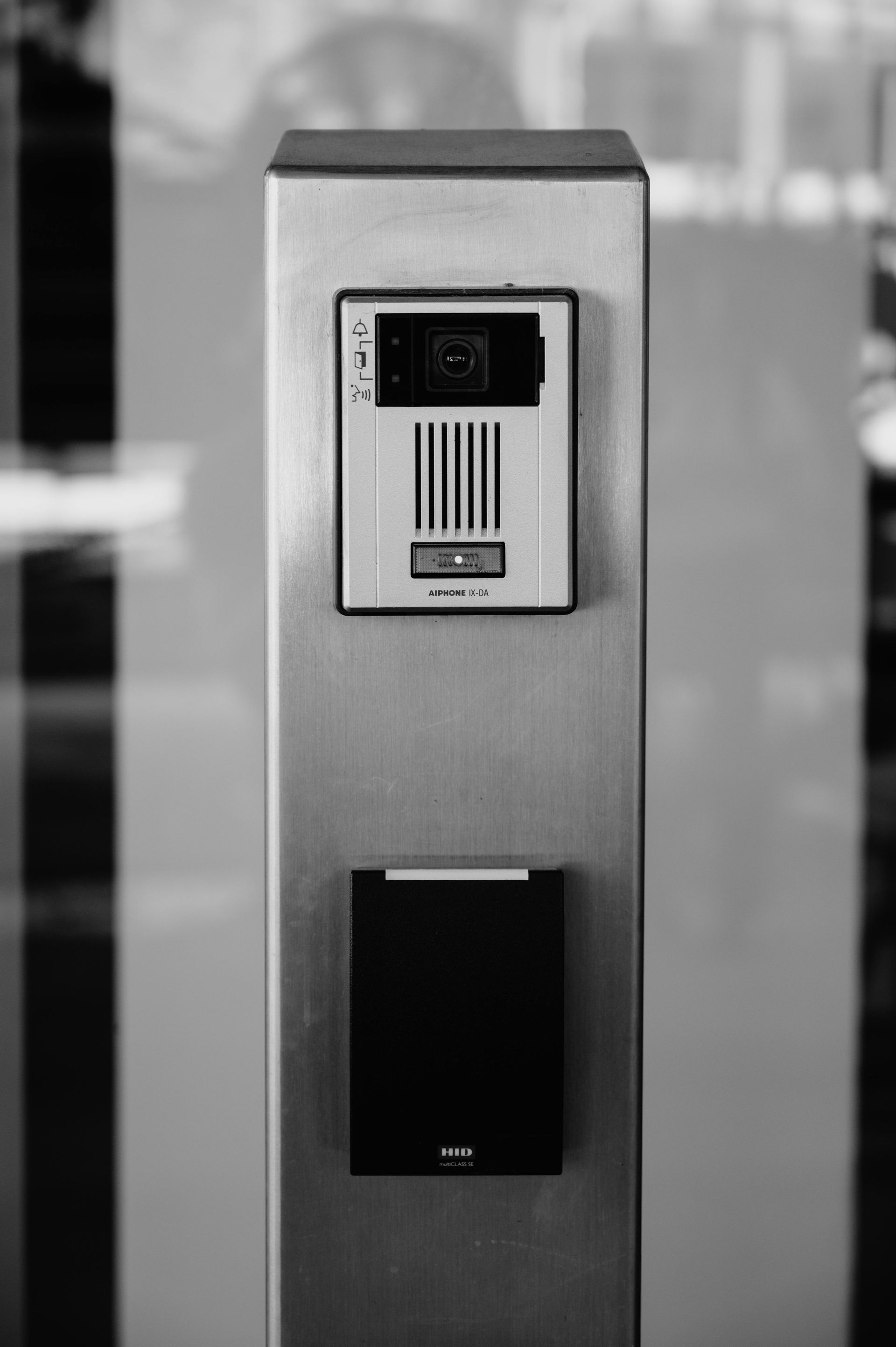Stainless steel intercom system with camera, keypad, and speaker.