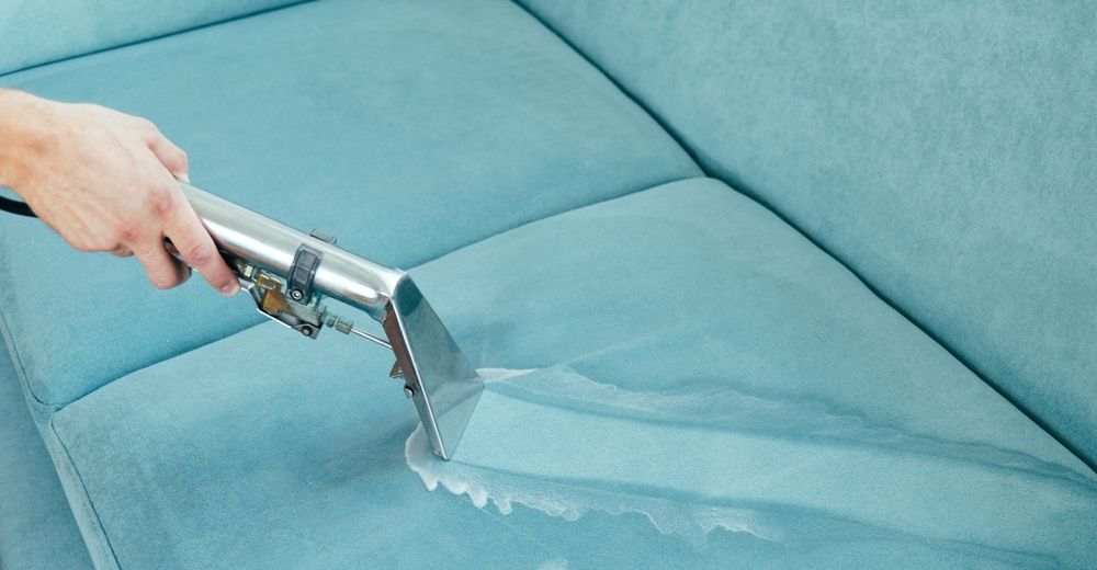 Person Cleaning a Light Blue Couch — Chemdry D & K in Geelong, VIC