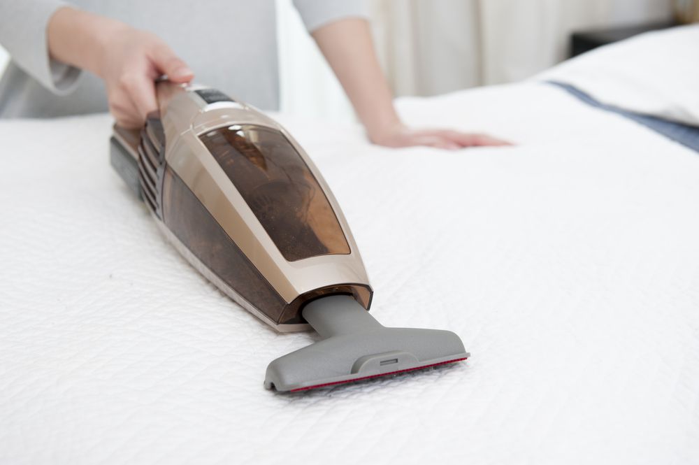 Person Vacuuming a White Mattress — Chemdry D & K in Geelong, VIC