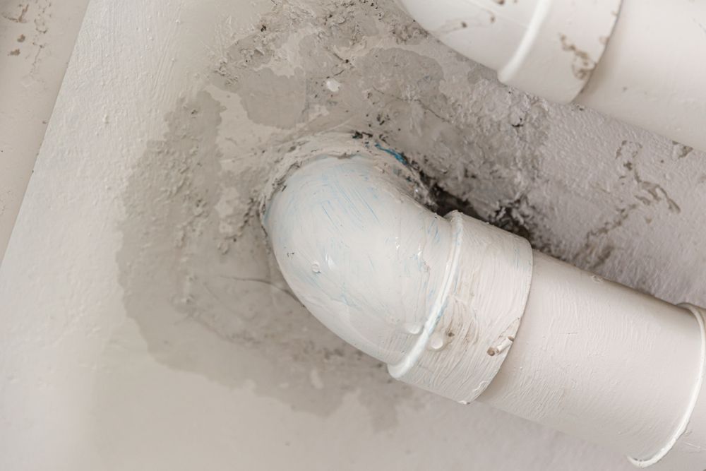 White PVC Pipes With An Elbow Joint — DSR Plumbing Pty Ltd in Ashtonfield, NSW