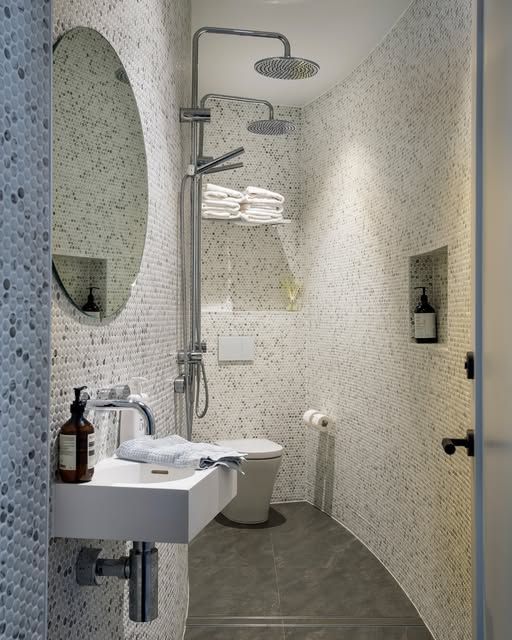 Narrow Modern Bathroom with Sink, Toilet, Shower, and Oval Mirror — DSR Plumbing Pty Ltd in Lake Macquarie, NSW