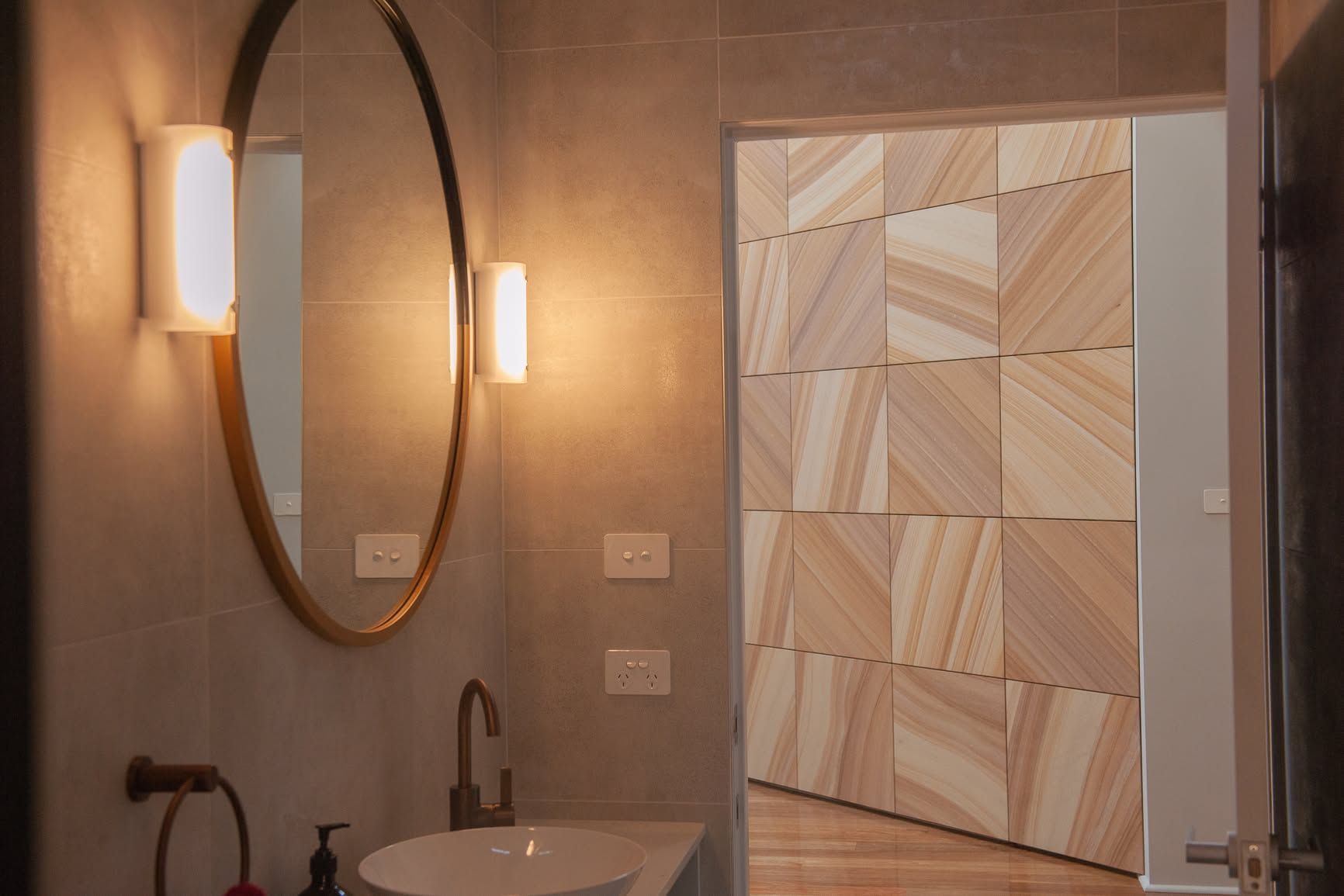 Modern Bathroom With Oval Mirror, Sink, Sconces, and Geometric Wood-paneled — DSR Plumbing Pty Ltd in Ashtonfield, NSW