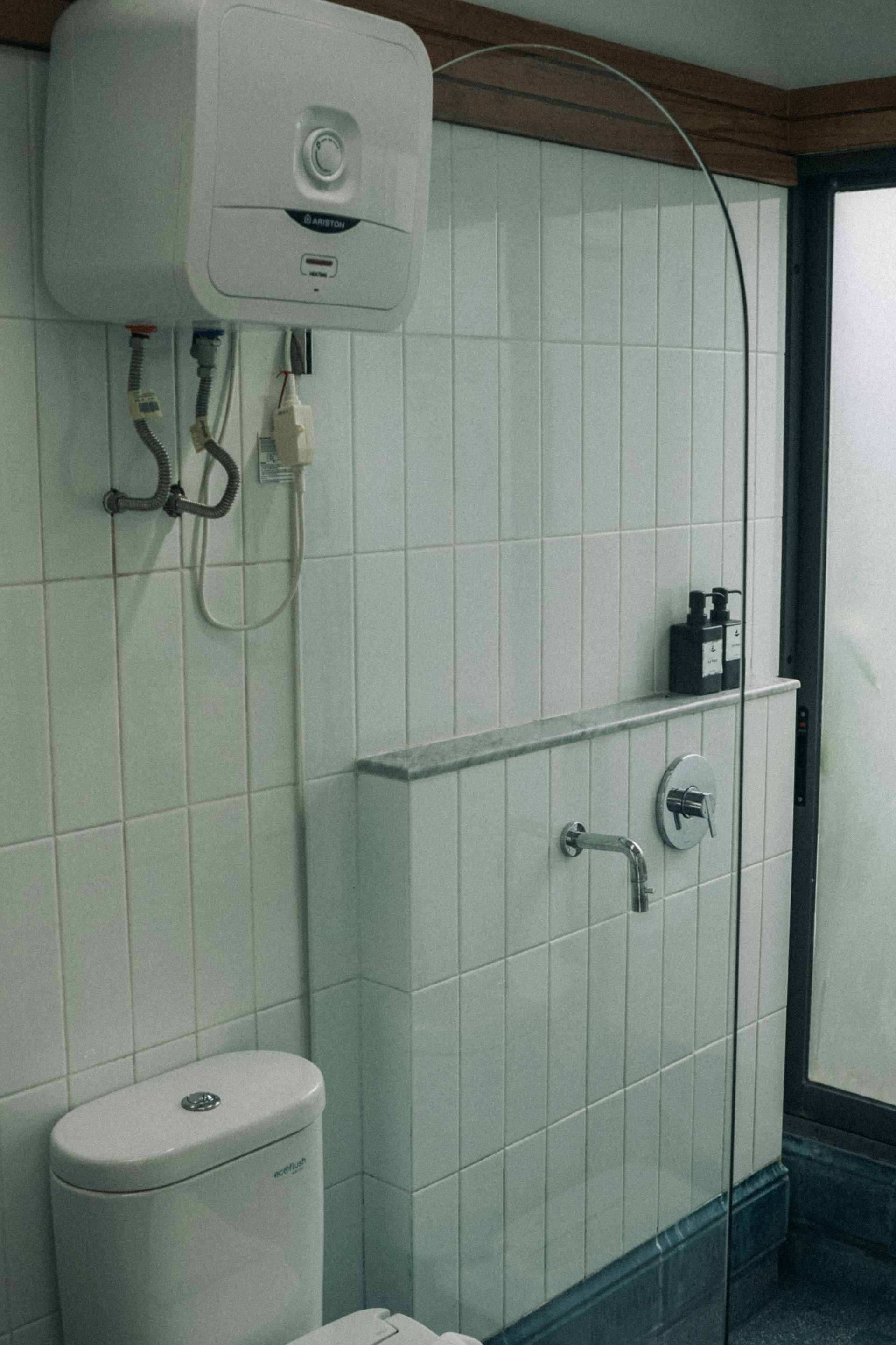 Bathroom With White Tiled Walls — DSR Plumbing Pty Ltd in Newcastle, NSW