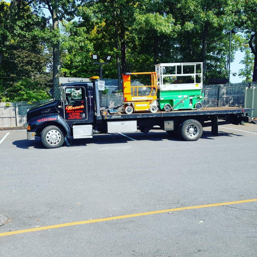 A tow truck with a lift on the back of it