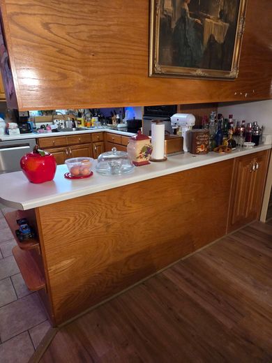 A kitchen under construction with white cabinets and a large island.