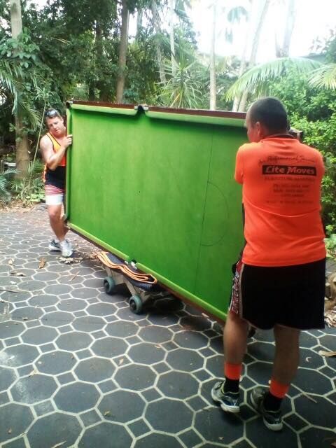 Removalists moving a pool table