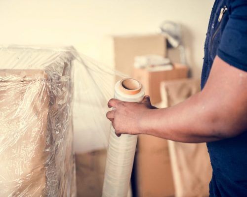 Crew doing a packaging service — Lite Moves Furniture Removals In Bonville, NSW