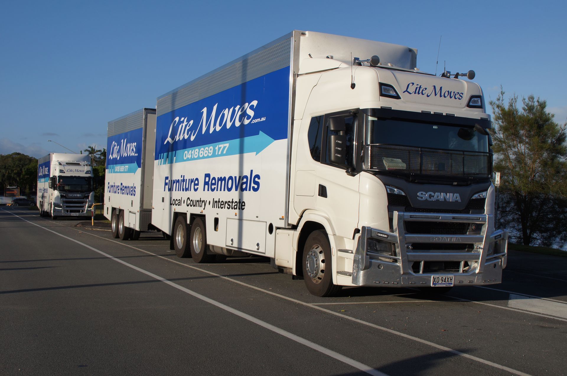 Truck fleet parked on the side of road - Lite Moves Furniture Removals In Bonville, NSW