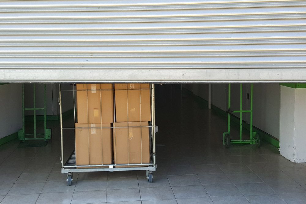Entrance Into Self Storage Units, Big Cart With Carton Boxes — Lite Moves Furniture Removals In Bonville, NSW