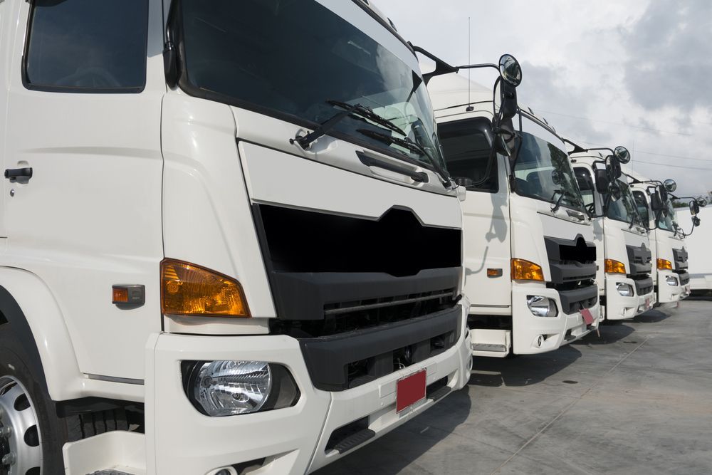 Row of White Trucks Are Parked in a Parking Lot — Lite Moves Furniture Removals In Sydney, NSW