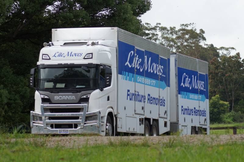 White truck with trailer driving on the road — Lite Moves Furniture Removals In Bonville, NSW