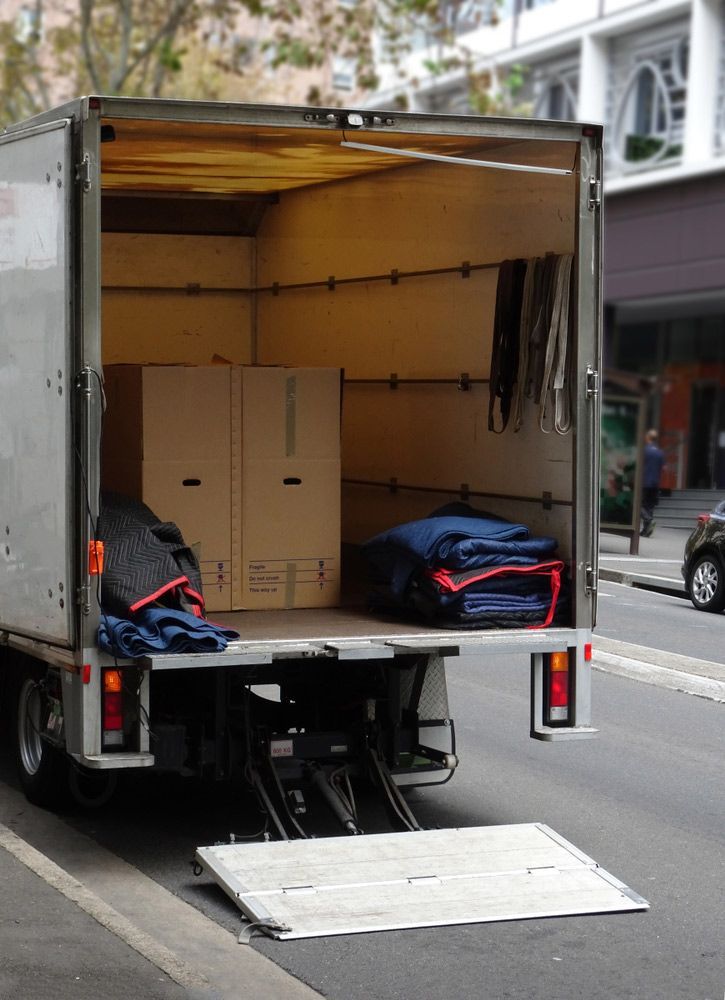 Side View Of Movers Carrying Refrigerator While Climbing Steps At Home — Lite Moves Furniture Removals In Bonville, NSW
