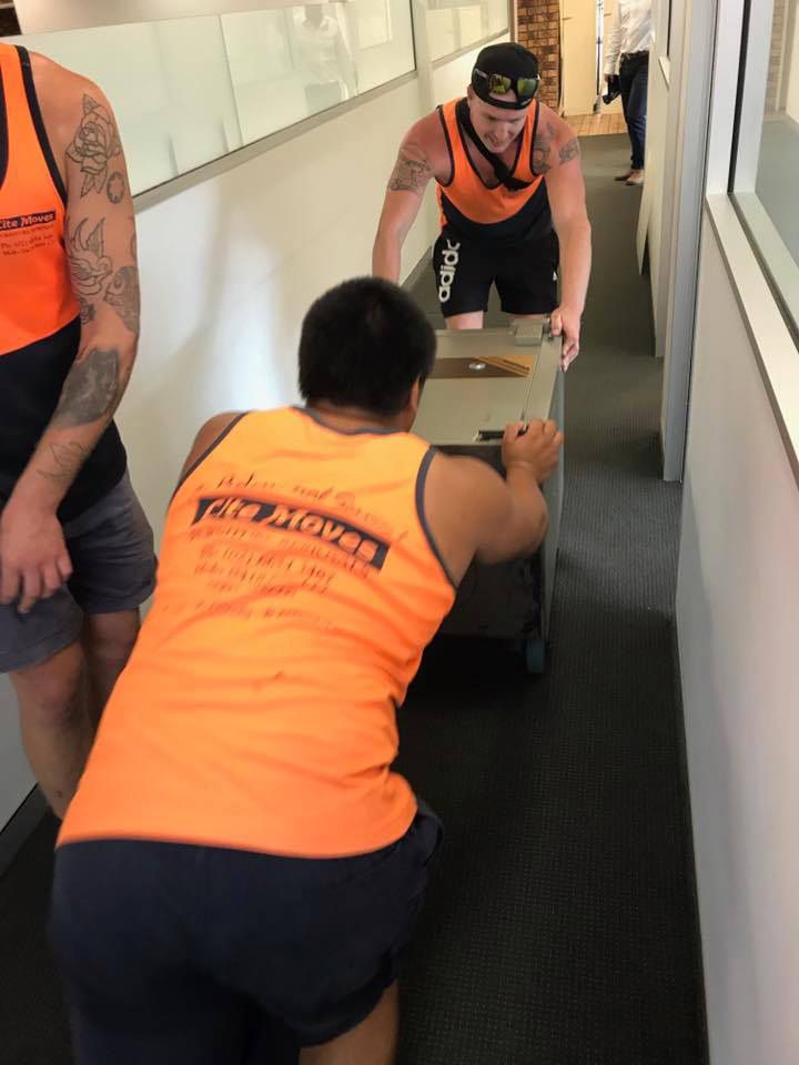 Three Movers With The Orange Uniforms Move The Office Furniture — Lite Moves Furniture Removals In Sunshine Coast, QLD