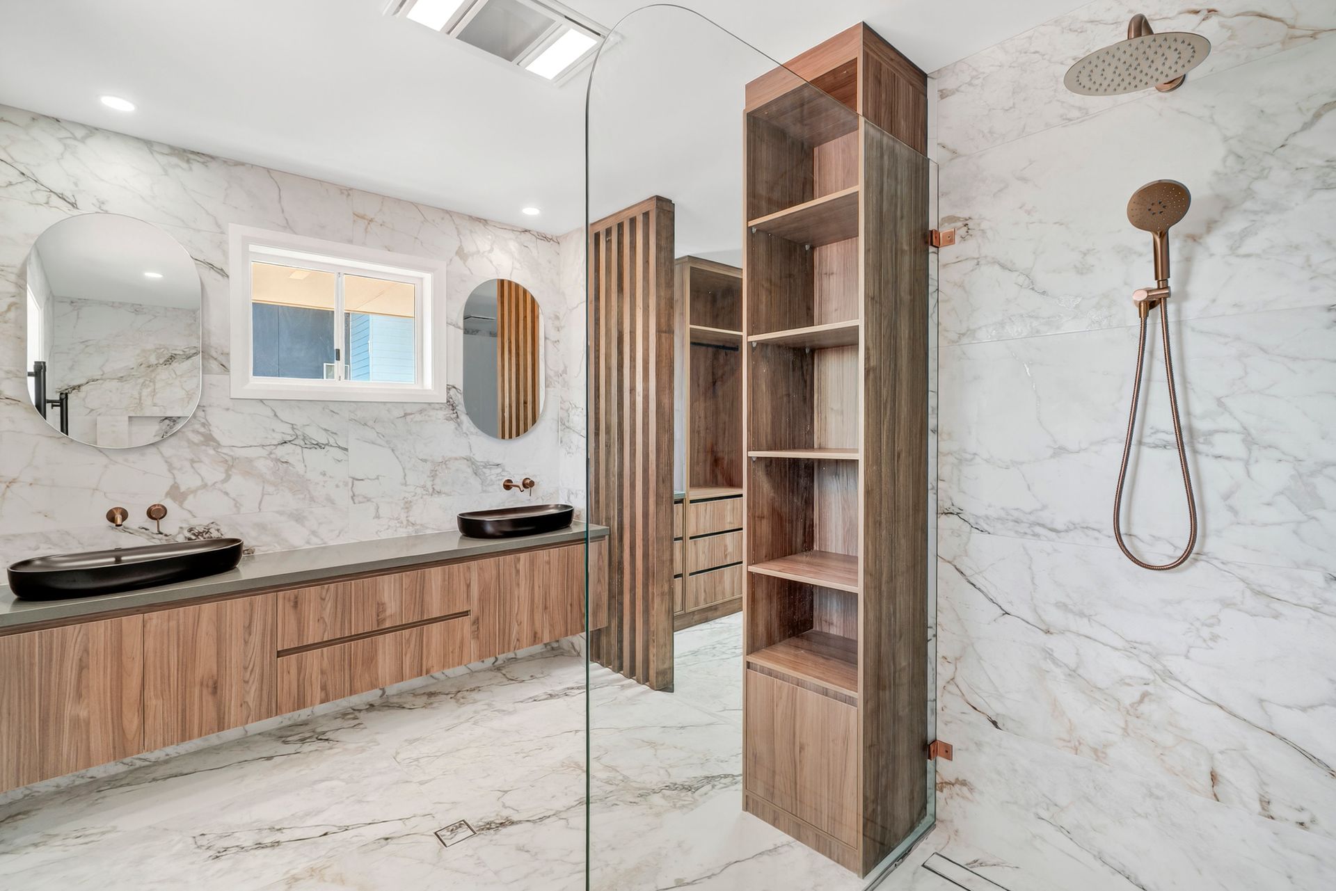 Modern bathroom with wood vanity, marble walls, and a glass-enclosed shower — PK4 Projects in Port Macquarie, NSW