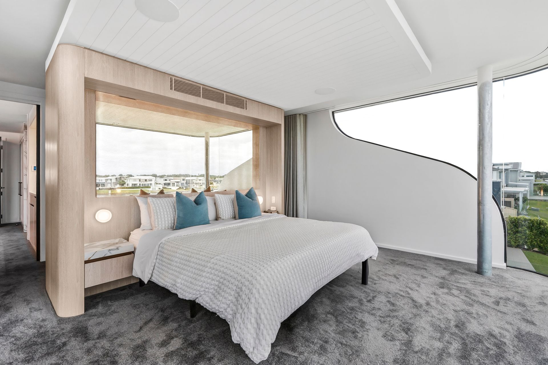 Bedroom with large window, bed with blue pillows, built-in bench, neutral tones, modern design — PK4 Projects in Port Macquarie, NSW
