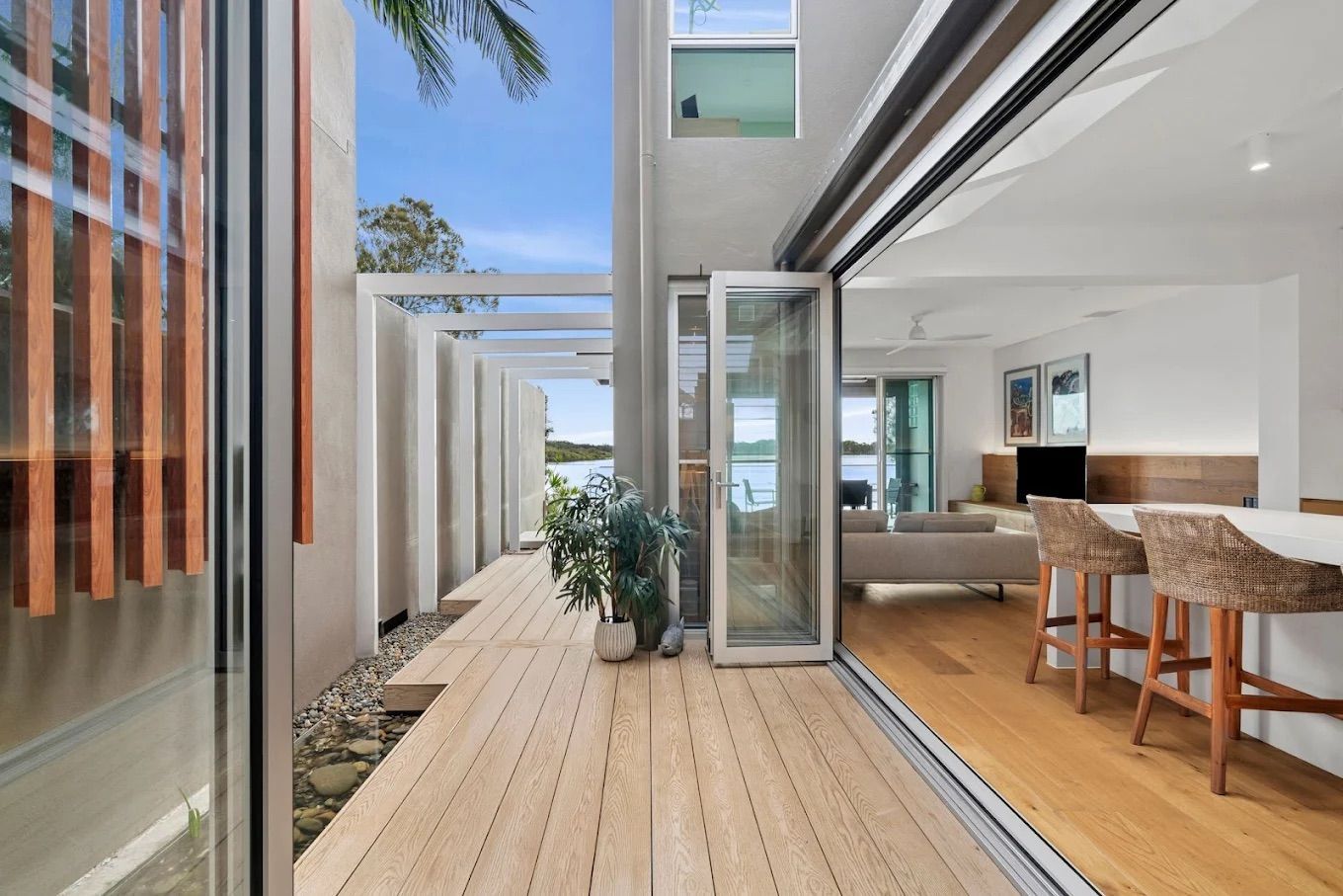 Outdoor Deck With Seating and Open Glass Doors — PK4 Projects in Port Macquarie, NSW