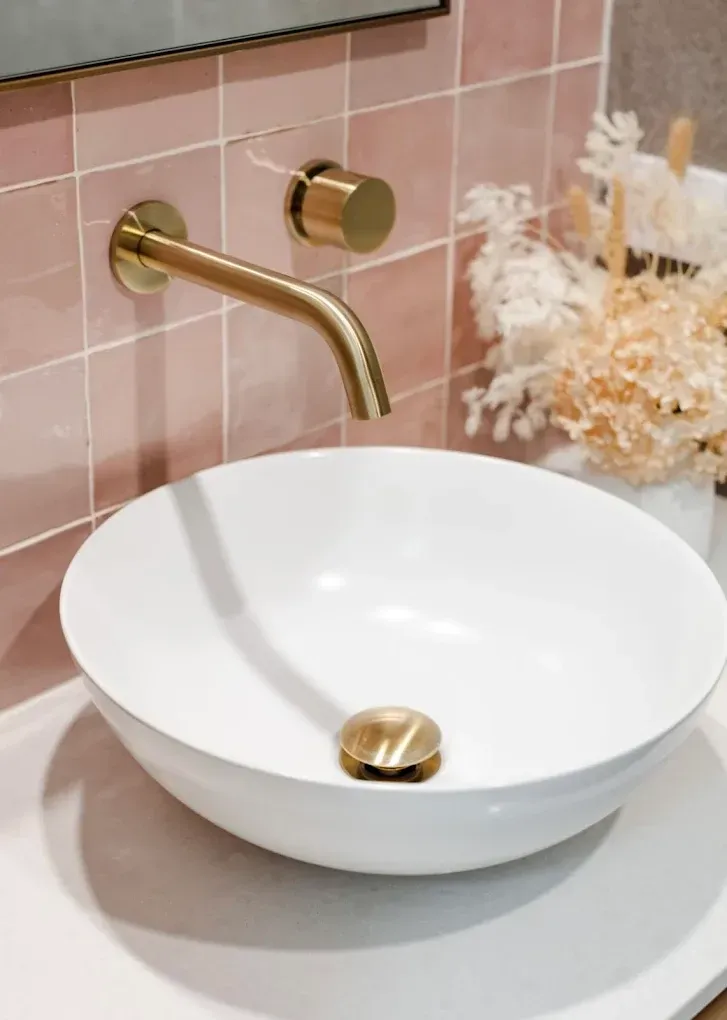Gold Faucet and Drain on White Basin, Pink Tiled Wall — PK4 Projects in Port Macquarie, NSW