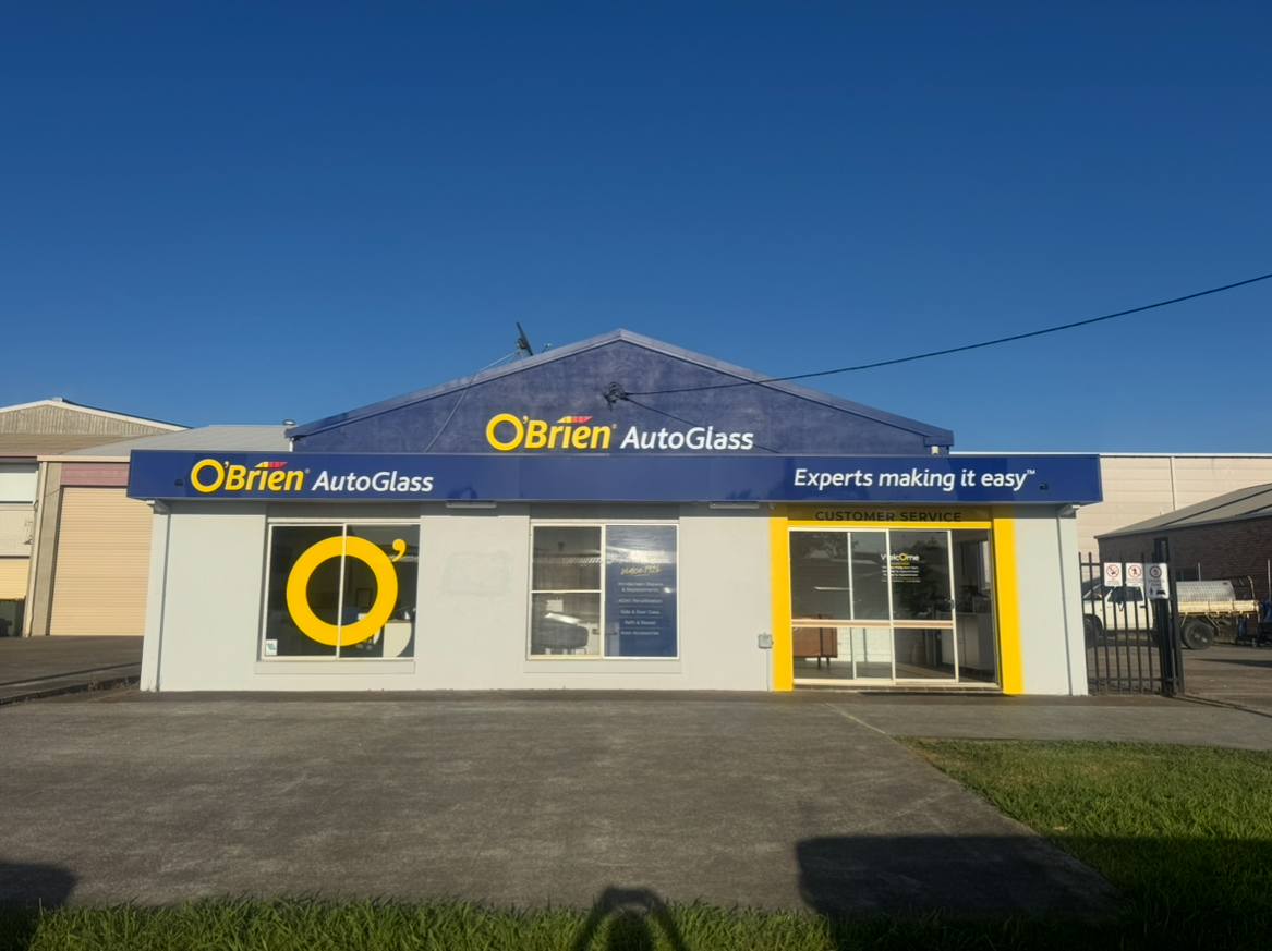 O'Brien AutoGlass storefront with blue and yellow branding against a clear blue sky  — PK4 Projects in Port Macquarie, NSW