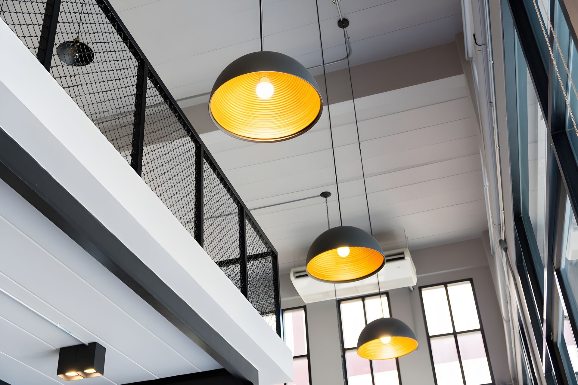 Low-angle view of three hanging pendant lights — PK4 Projects in Port Macquarie, NSW