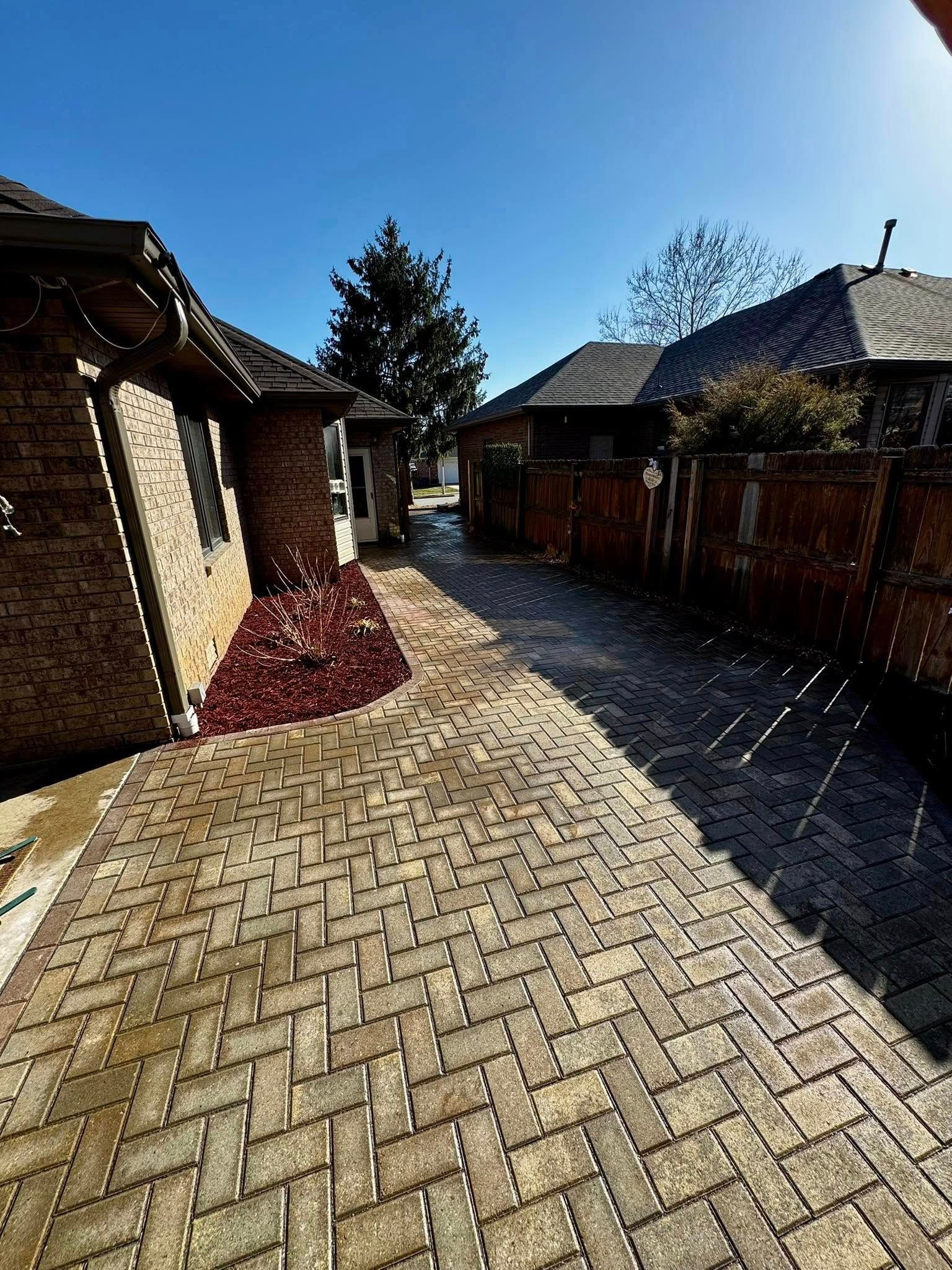 A close up of a brick pavement with a herringbone pattern