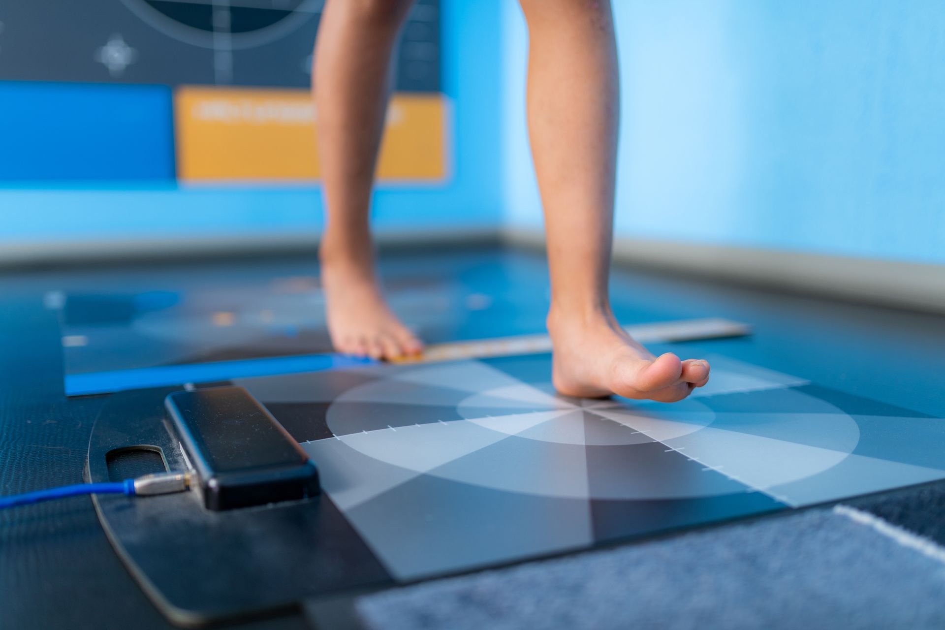 A person is standing on a mat with their feet on it.