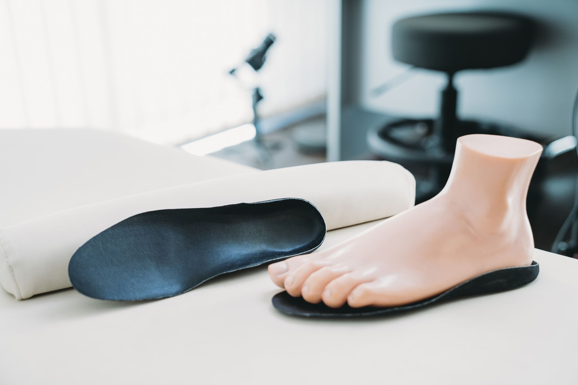 A pair of insoles and a foot on a table