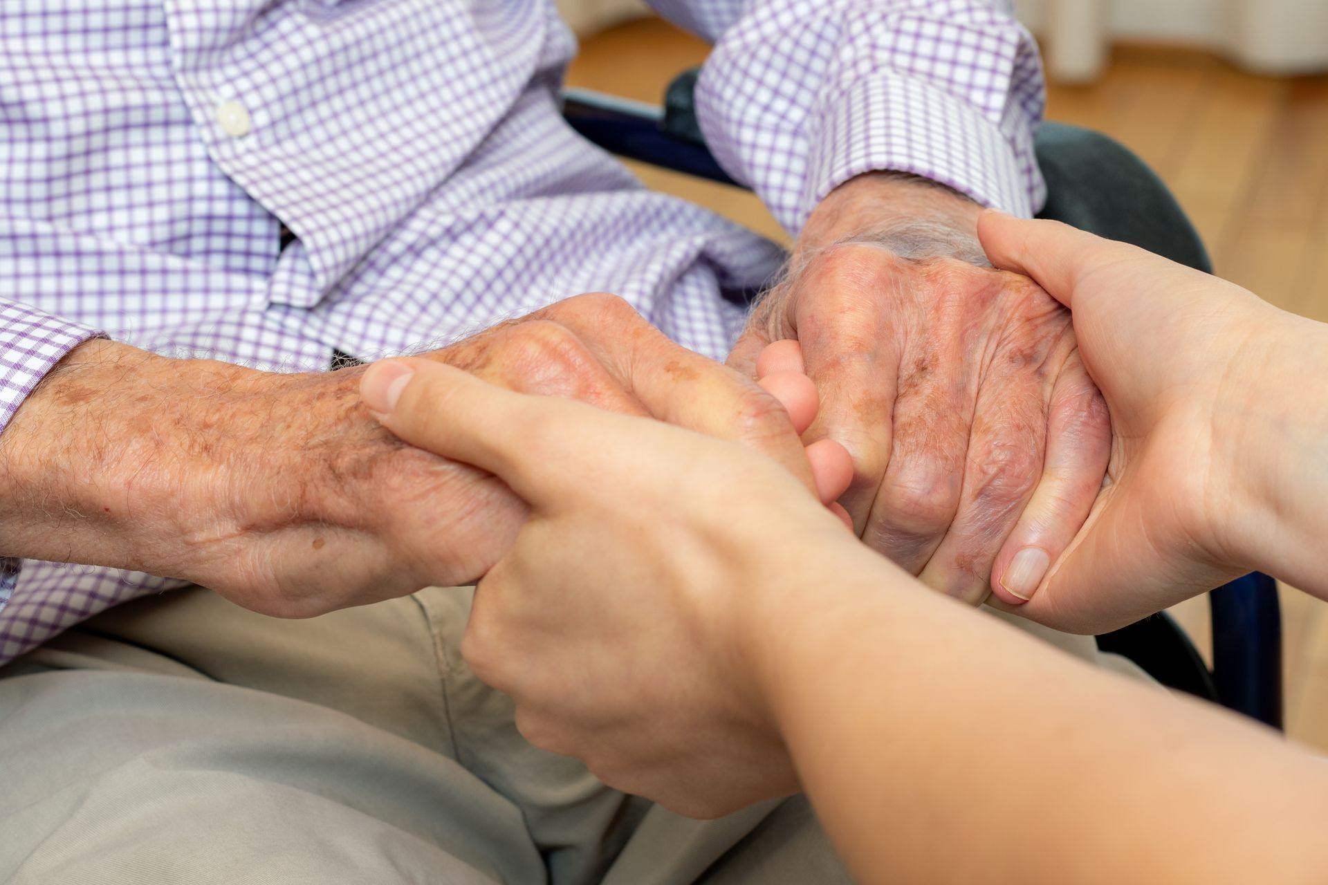 Close-up of young and old hands as they hold each other. Close-up of young and old hands as they hold each other.