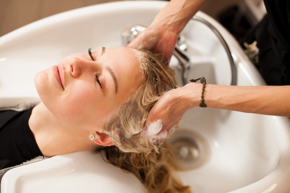 Ladies Head In Sink With Hair Being Washed in Hairdressing Salon — Sampson Plumbing Pty Ltd In Casuarina, NSW