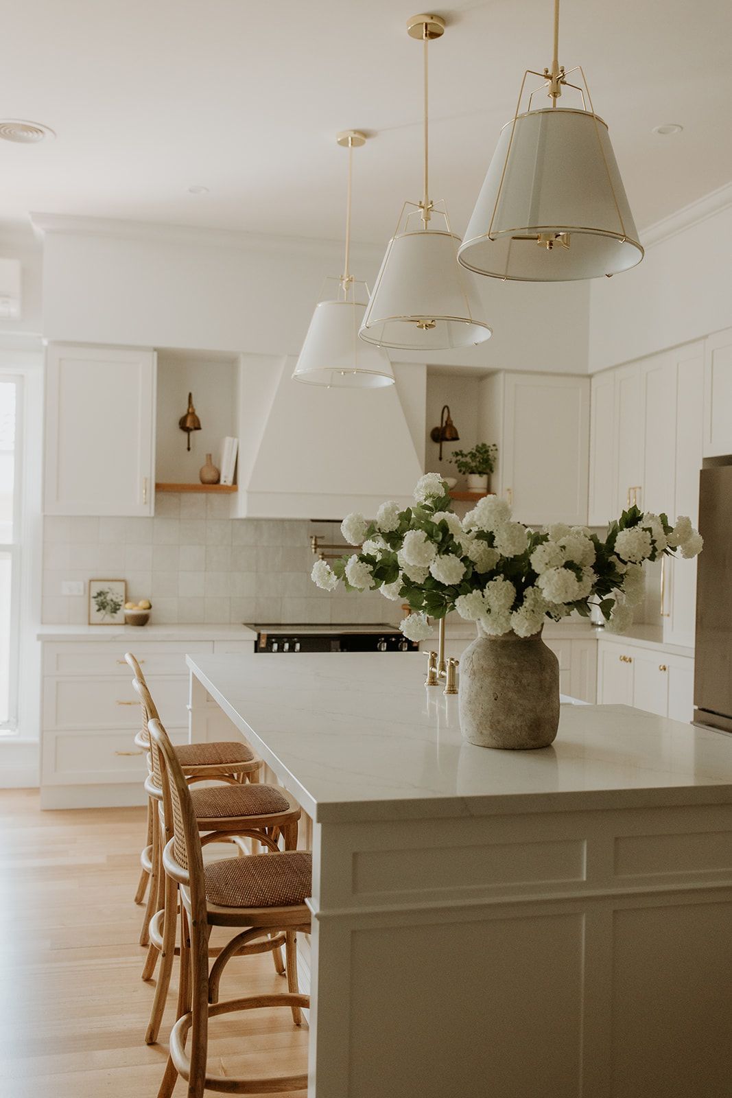 Painted shaker profile cabinetry in Classic White paired with Stone Ambassador Marbella benchtop on kitchen island and surounding cabinetry.