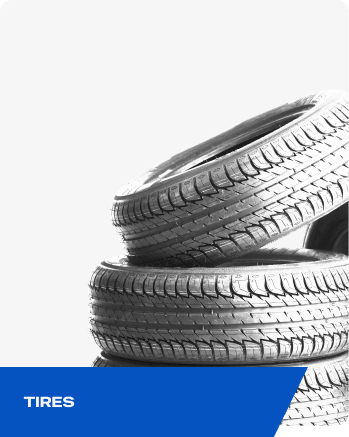 Stacked car tires with blue banner labeled “TIRES” | Elite Automotive & Diesel Repair