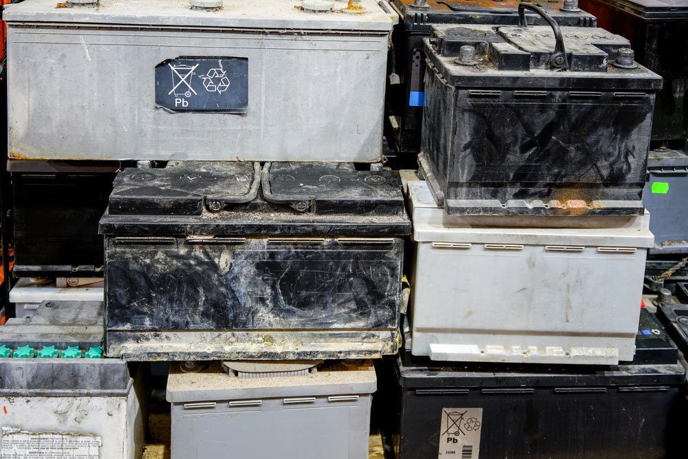 A Pile of Old Batteries Are Stacked on Top of Each Other — Bakers Creek Wreckers In Emu Park, QLD