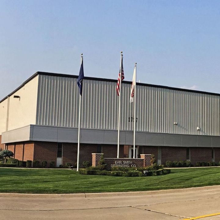 A large building with flags in front of it