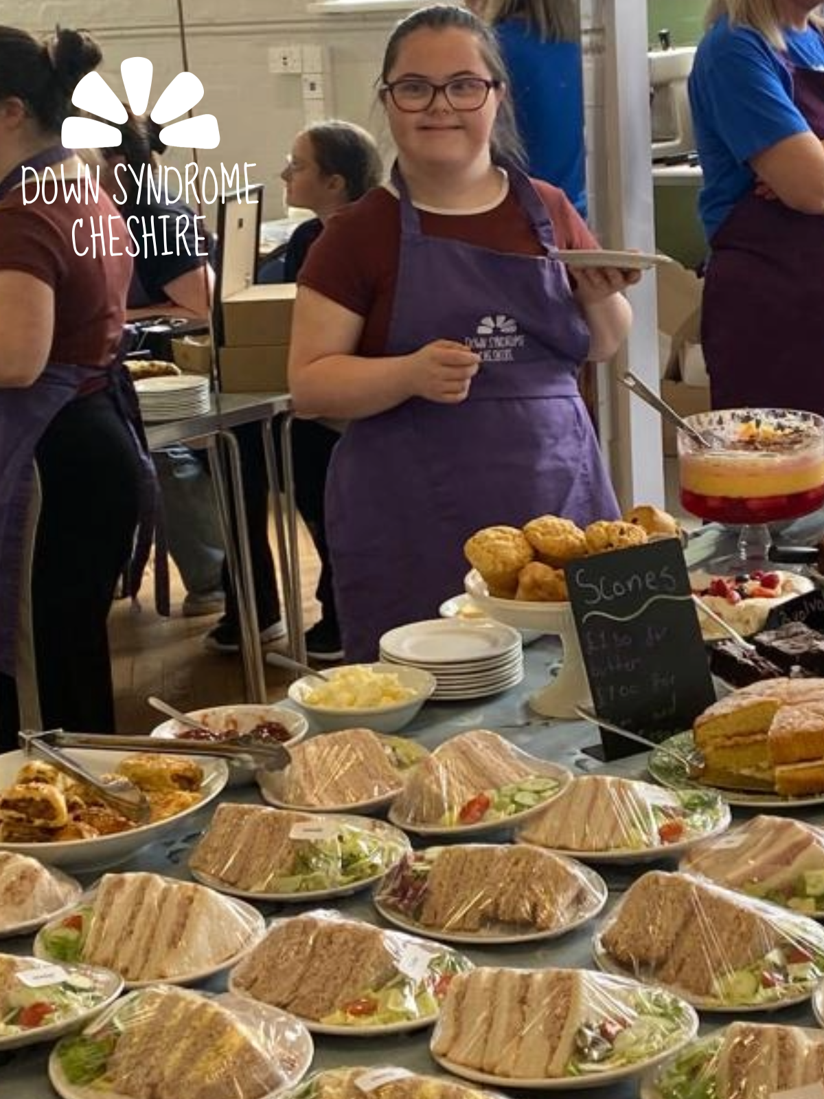 A young adult with Down syndrome serving afternoon teas