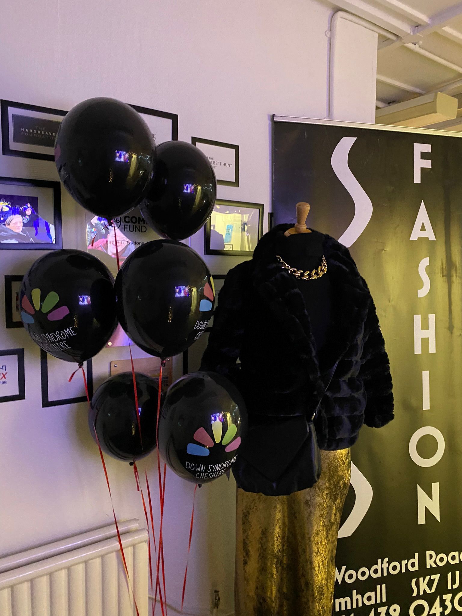 a mannequin in front of a sign that says fashion