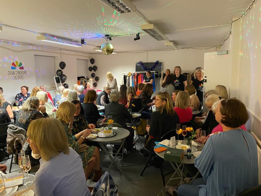 a large group of people are sitting at tables in a room .