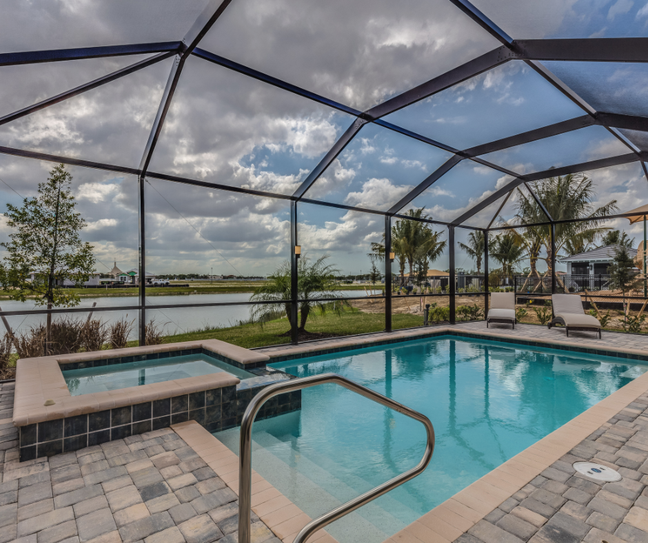 Pool and spa enclosed in screen, view of water and sky.