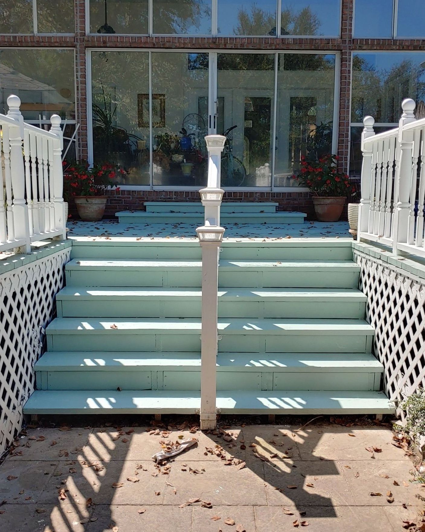 A set of stairs leading up to a building with a white railing