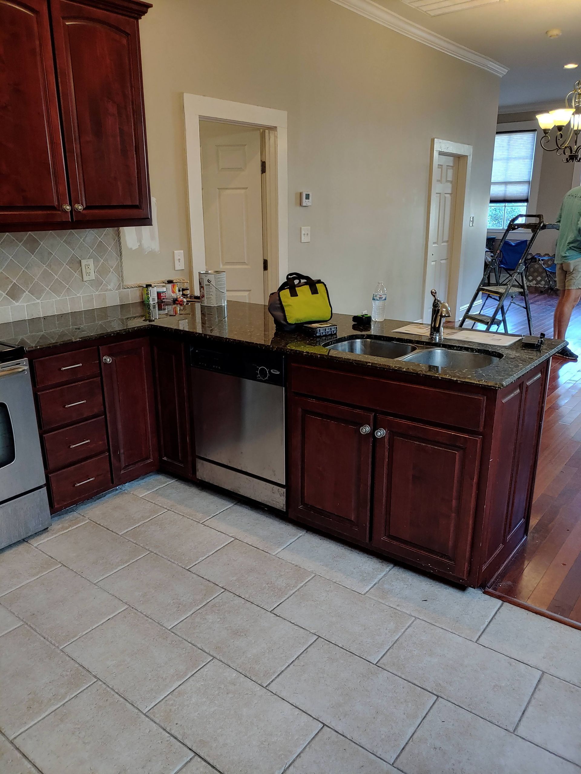 A kitchen with stainless steel appliances and wooden cabinets.
