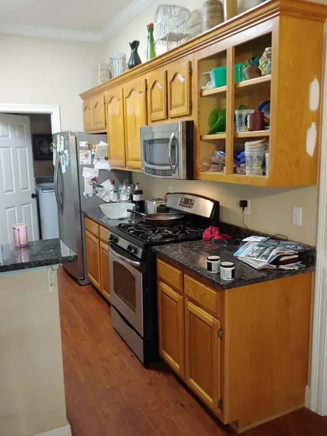 A kitchen with stainless steel appliances and wooden cabinets