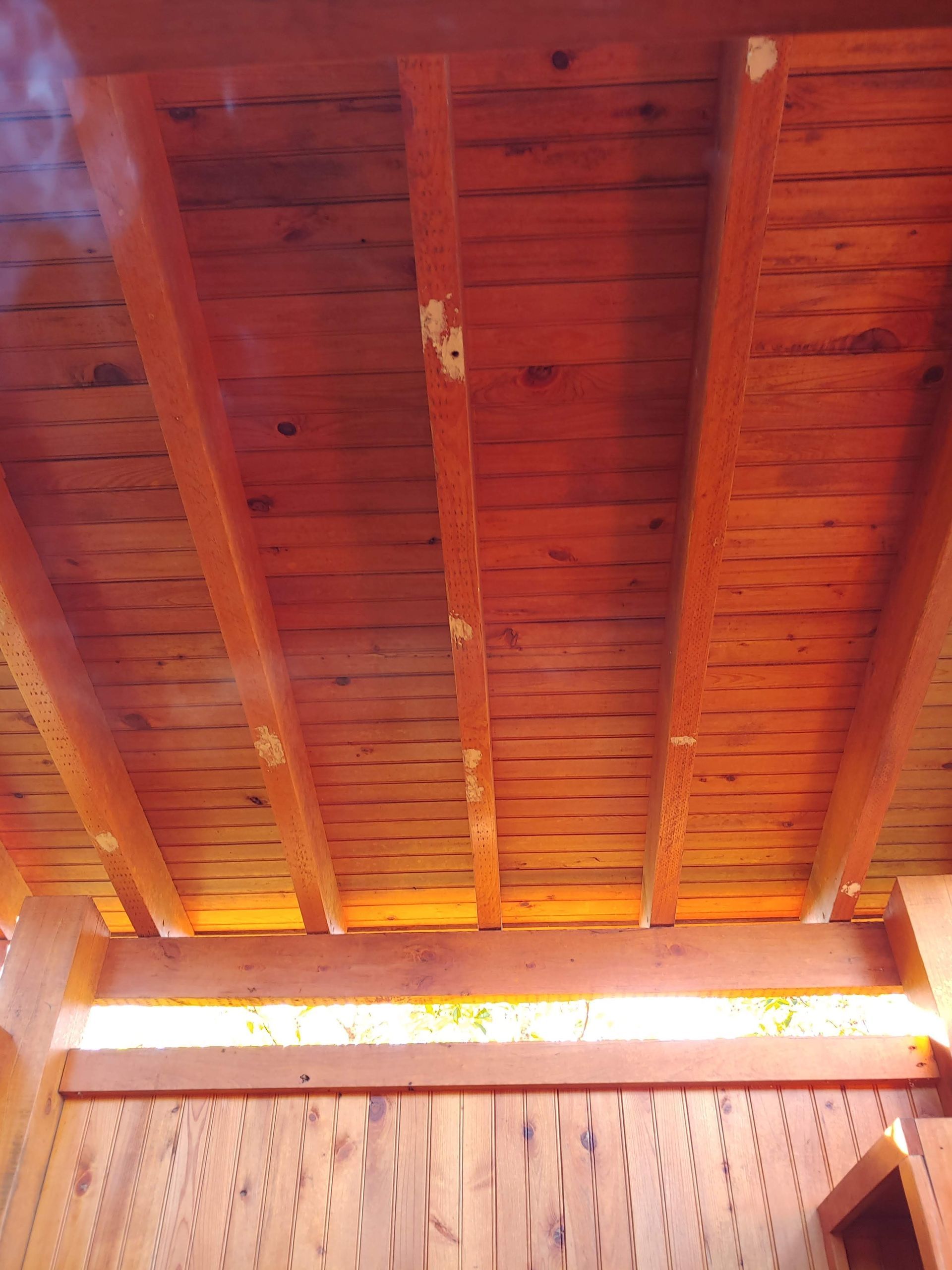 A close up of a wooden ceiling in a room.